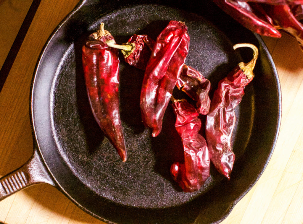 Chiles roasting in iron skillet