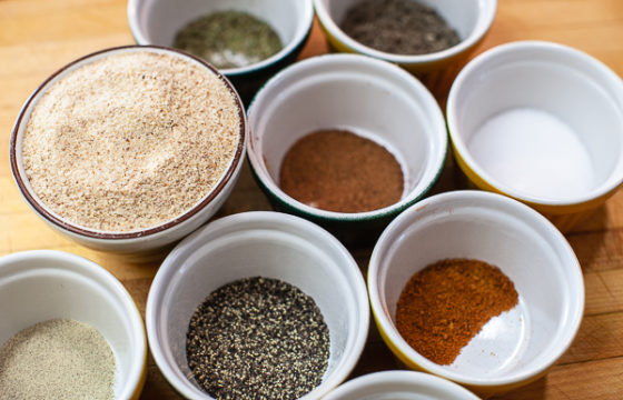 various spices in bowls on cutting board