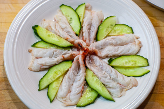 butterflied shrimp and cucumber slices on white plate