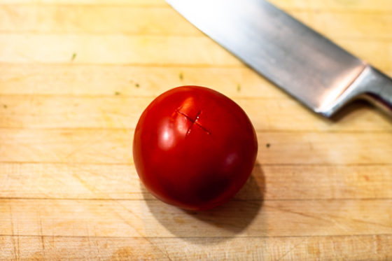 To peel a tomato cut an X into the bottom of the tomato.