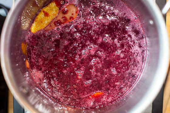 cherry syrup reducing in sauce pan with lemon zests