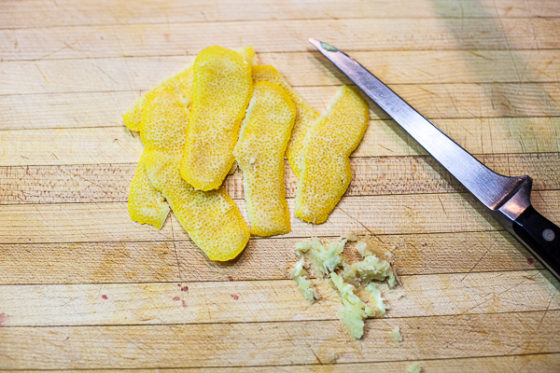 strips of lemon peel on cutting board with pith removed