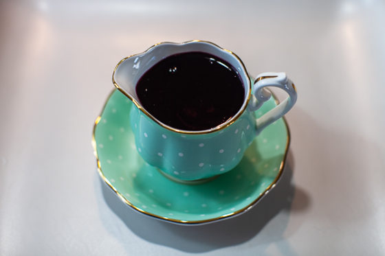 turquoise creamer cup full of cherry syrup