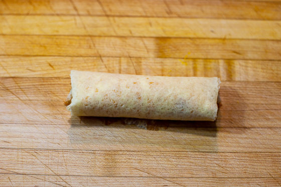 crepe rolled up on cutting board