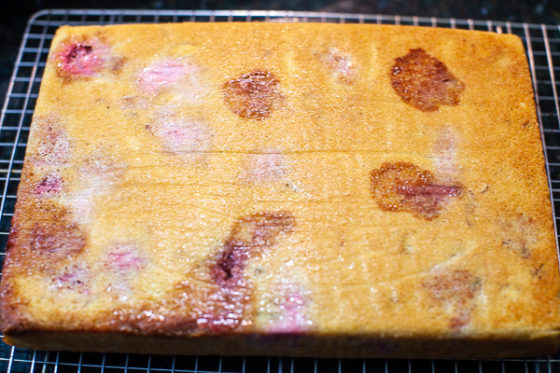 cake on cooling rack with parchment paper removed