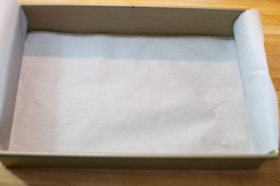 baking pan containing folded parchment over width edge