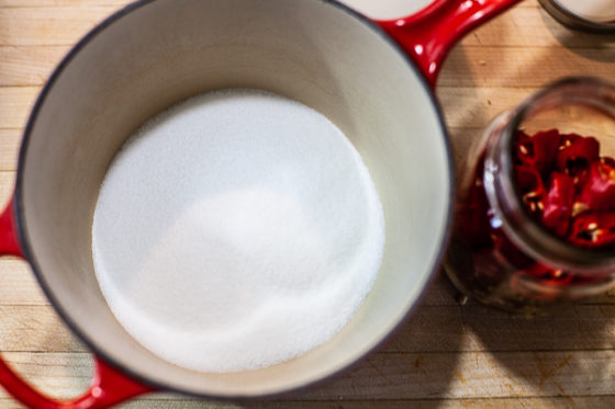 pot containing sugar and salt on cutting board