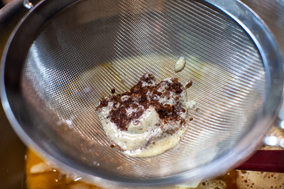 sieve containing brown butter solids