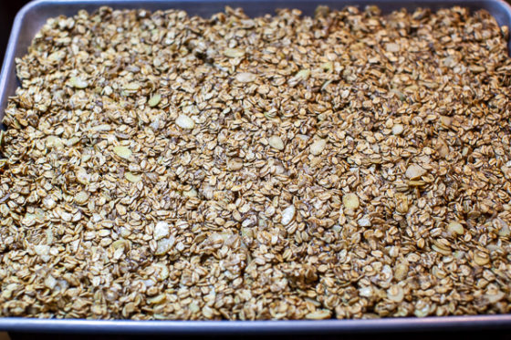 sheet pan containing granola spread to the edges