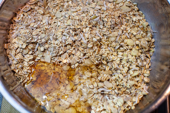 mixing bowl containing oatmeal mixture with honey added on top