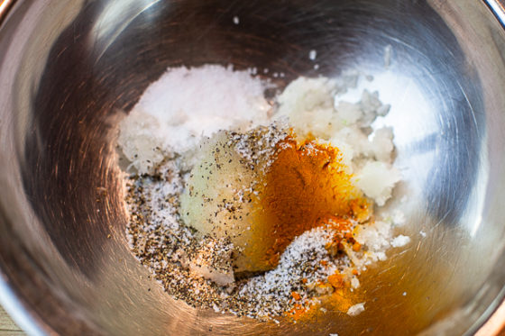 minced onion, turmeric, salt, black peper and saffron water in metal mixing bowl