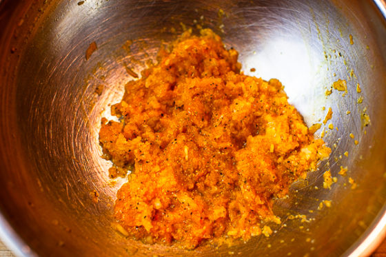 minced onion, salt, papper, turmeric, saffron water and egg mixed together in metal mixing bowl