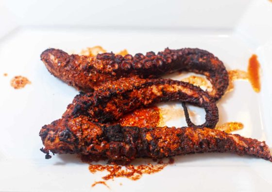 Charred Octopus on a white plate.